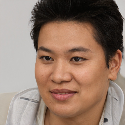 Joyful asian young-adult female with short  brown hair and brown eyes