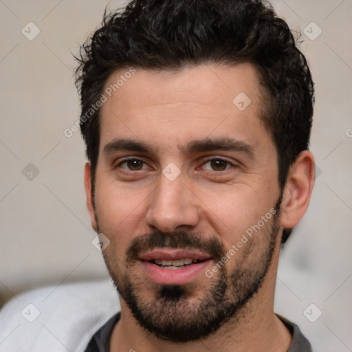 Joyful white young-adult male with short  black hair and brown eyes