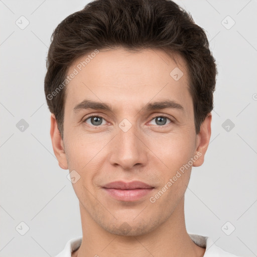 Joyful white young-adult male with short  brown hair and grey eyes