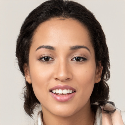 Joyful latino young-adult female with long  brown hair and brown eyes