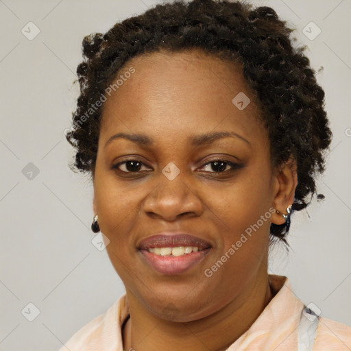 Joyful black adult female with short  brown hair and brown eyes