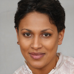 Joyful black adult female with short  brown hair and brown eyes