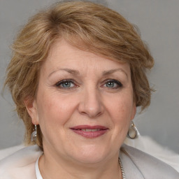 Joyful white adult female with medium  brown hair and blue eyes