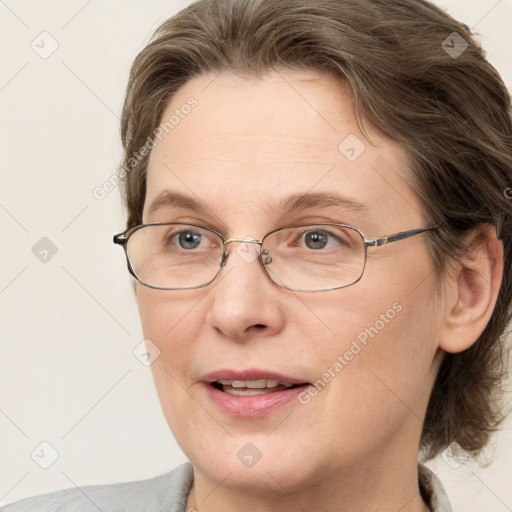 Joyful white adult female with medium  brown hair and blue eyes