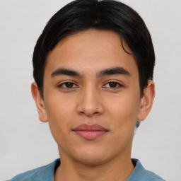 Joyful latino young-adult male with short  brown hair and brown eyes