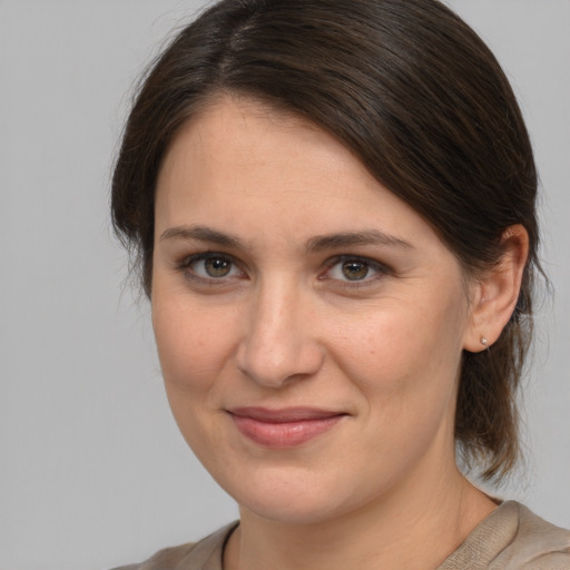 Joyful white young-adult female with medium  brown hair and brown eyes