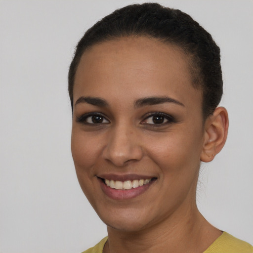 Joyful latino young-adult female with short  brown hair and brown eyes