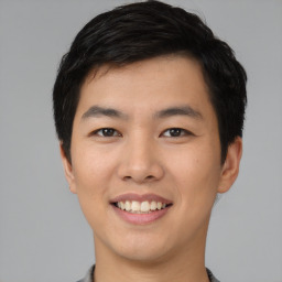 Joyful asian young-adult male with short  black hair and brown eyes