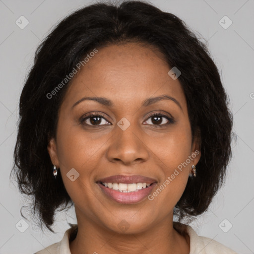 Joyful black adult female with medium  brown hair and brown eyes