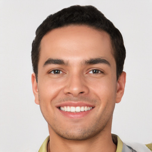 Joyful white young-adult male with short  black hair and brown eyes