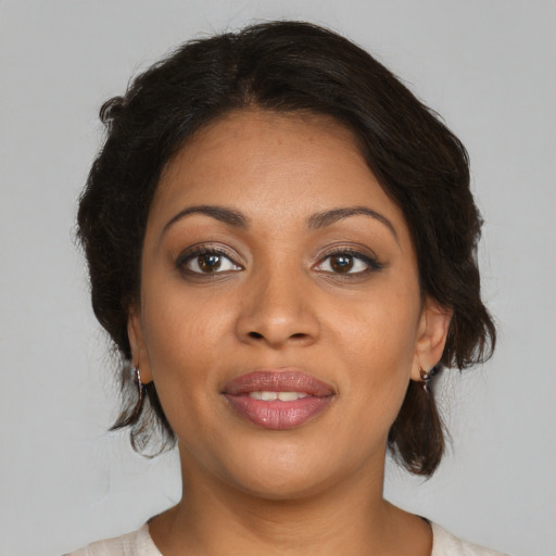 Joyful black young-adult female with medium  brown hair and brown eyes
