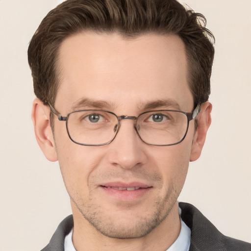 Joyful white adult male with short  brown hair and grey eyes