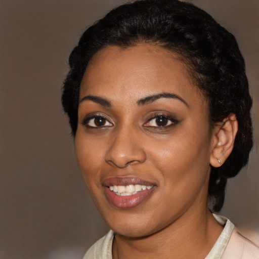 Joyful black young-adult female with short  black hair and brown eyes
