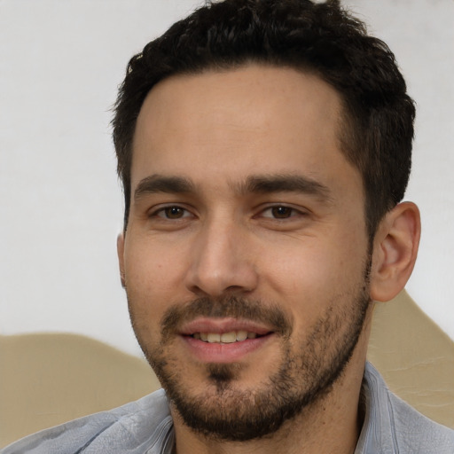 Joyful white young-adult male with short  black hair and brown eyes