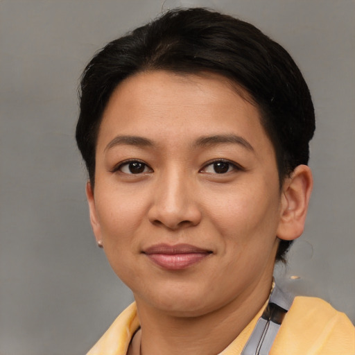Joyful asian young-adult female with short  brown hair and brown eyes
