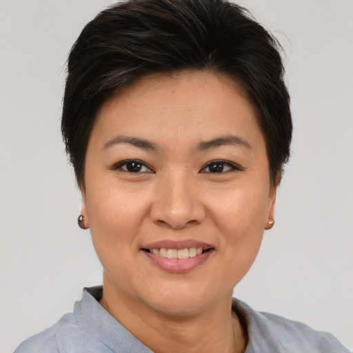 Joyful asian young-adult female with short  brown hair and brown eyes
