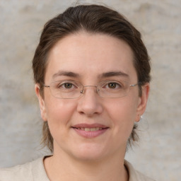 Joyful white adult female with medium  brown hair and grey eyes