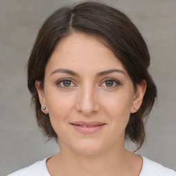 Joyful white young-adult female with medium  brown hair and brown eyes