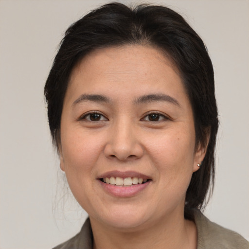 Joyful asian young-adult female with medium  brown hair and brown eyes