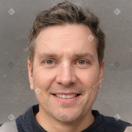 Joyful white adult male with short  brown hair and grey eyes