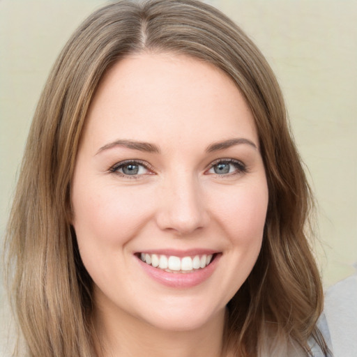 Joyful white young-adult female with long  brown hair and green eyes