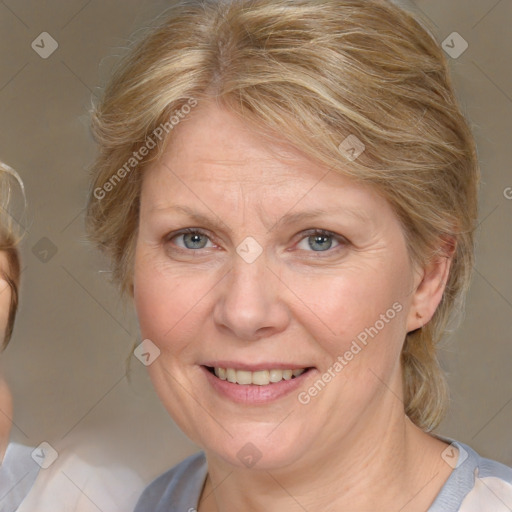 Joyful white adult female with medium  brown hair and blue eyes