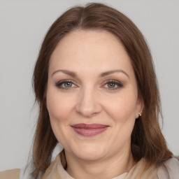 Joyful white adult female with medium  brown hair and grey eyes