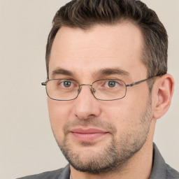 Joyful white adult male with short  brown hair and brown eyes