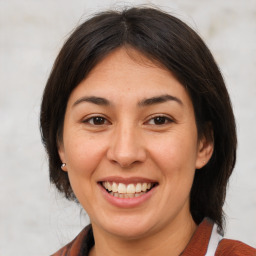 Joyful white adult female with medium  brown hair and brown eyes