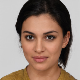 Joyful latino young-adult female with medium  brown hair and brown eyes