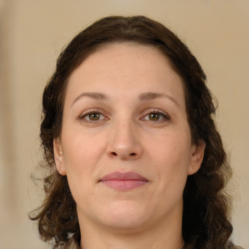 Joyful white adult female with medium  brown hair and green eyes