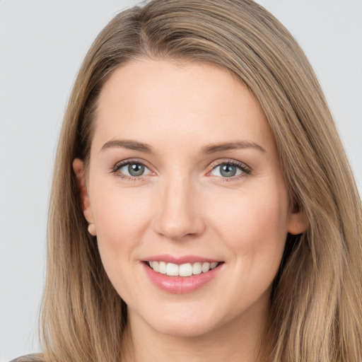 Joyful white young-adult female with long  brown hair and grey eyes