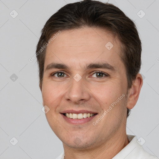 Joyful white young-adult male with short  brown hair and brown eyes