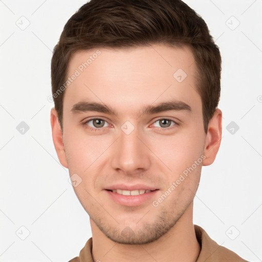 Joyful white young-adult male with short  brown hair and grey eyes