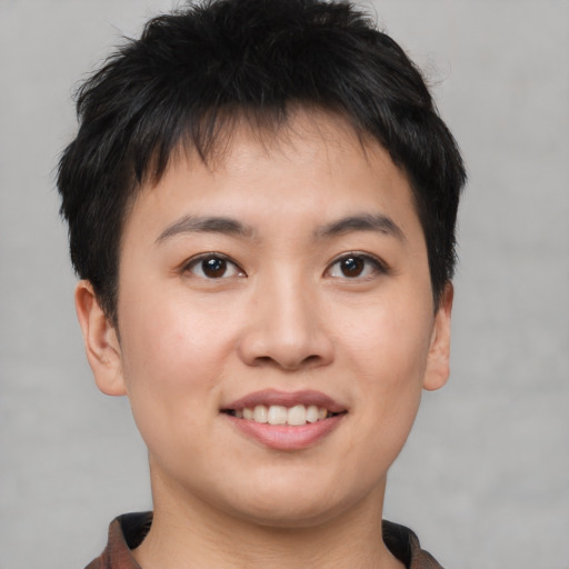 Joyful asian young-adult male with short  brown hair and brown eyes