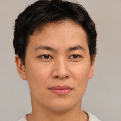 Joyful asian young-adult male with short  brown hair and brown eyes