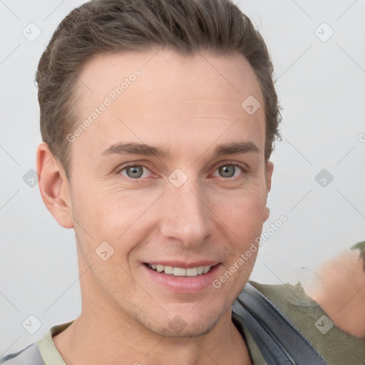 Joyful white young-adult male with short  brown hair and grey eyes