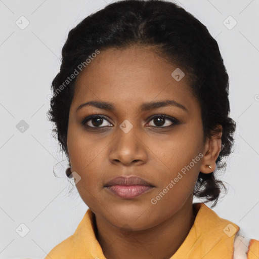 Joyful black young-adult female with long  black hair and brown eyes