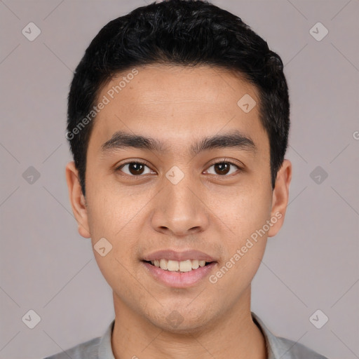 Joyful white young-adult male with short  black hair and brown eyes