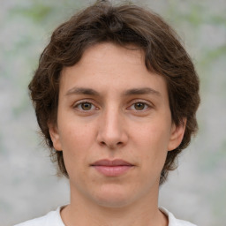 Joyful white young-adult female with medium  brown hair and green eyes