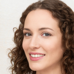 Joyful white young-adult female with long  brown hair and green eyes