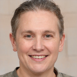 Joyful white adult male with short  brown hair and grey eyes