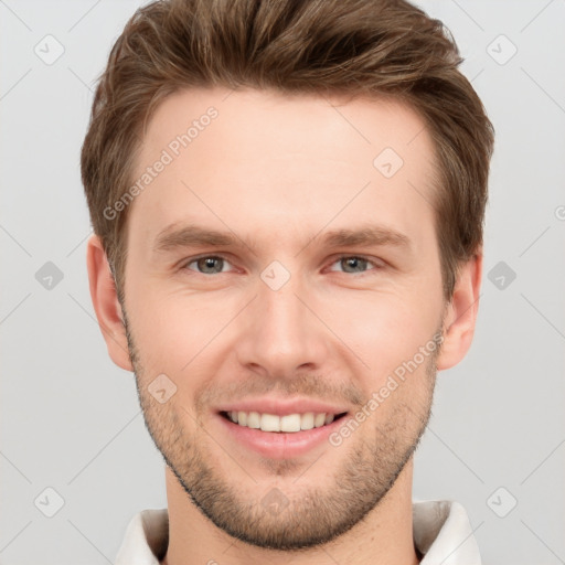 Joyful white young-adult male with short  brown hair and grey eyes