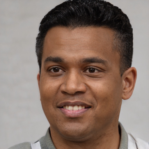 Joyful latino young-adult male with short  black hair and brown eyes