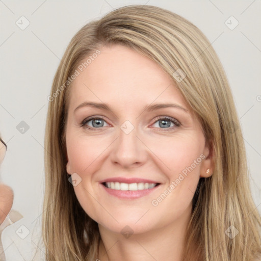 Joyful white young-adult female with long  brown hair and blue eyes