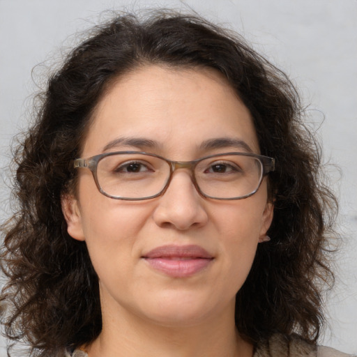 Joyful white adult female with medium  brown hair and brown eyes