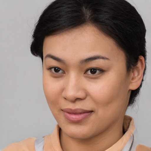 Joyful asian young-adult female with medium  brown hair and brown eyes