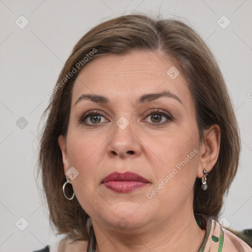 Joyful white adult female with medium  brown hair and grey eyes