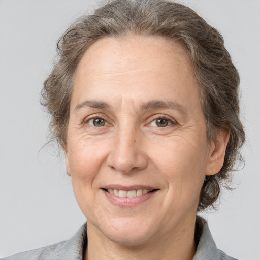 Joyful white middle-aged female with medium  brown hair and brown eyes