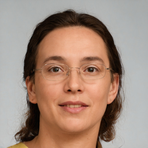 Joyful white adult female with medium  brown hair and brown eyes